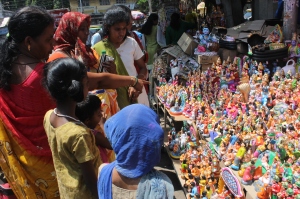 Customers negotiating prices with big doll vendors in Mylapore